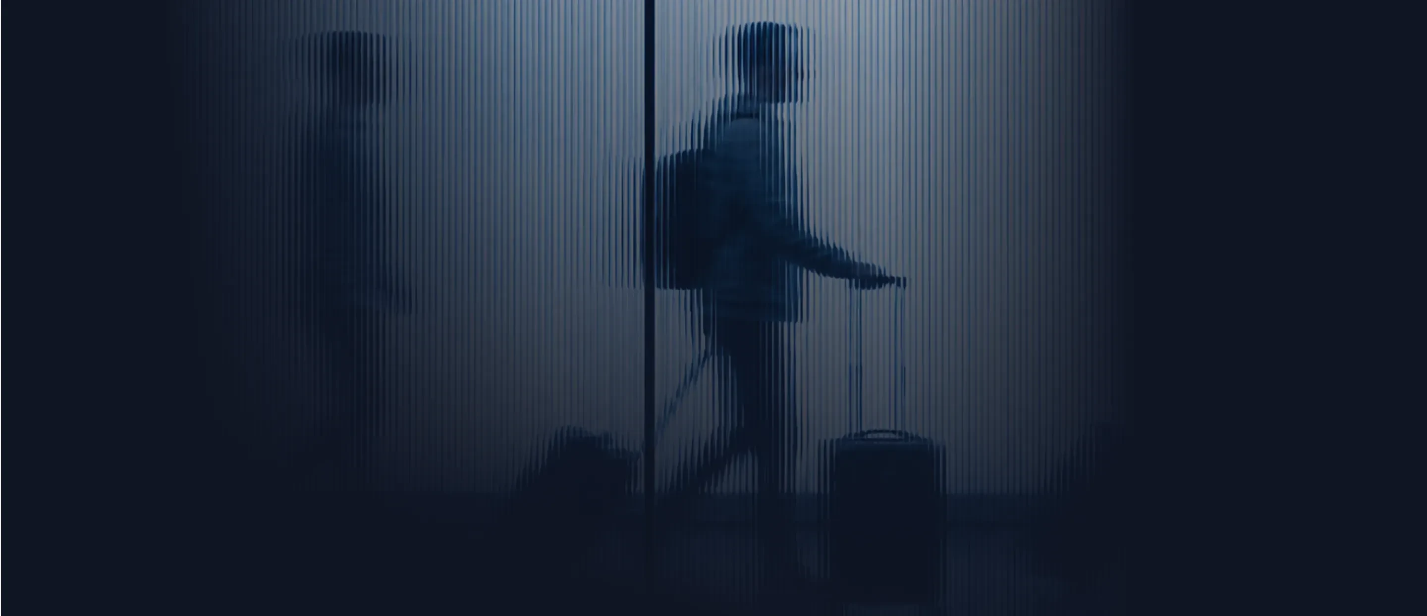 A traveller walking through an airport with a carry-on case